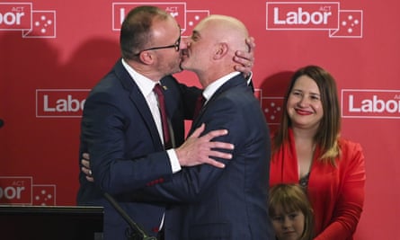 Andrew Barr (left) kisses his partner Anthony Toms as he delivers his ACT election victory speech on Saturday evening.