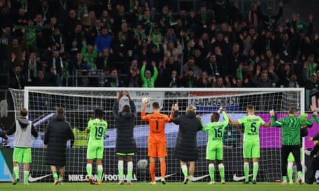 Wolfsburg players celebrate in front of their fans after the 1-0 defeat of Augsburg.