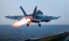 US fighter jet rolls off aircraft carrier as ship reportedly swerves Houthi fire