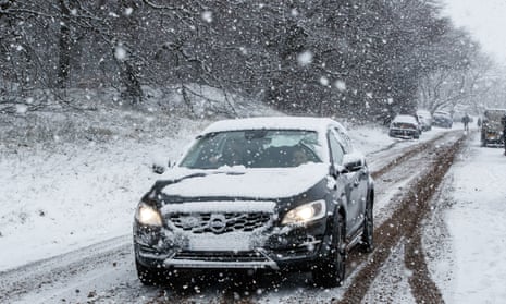A car drives through snow