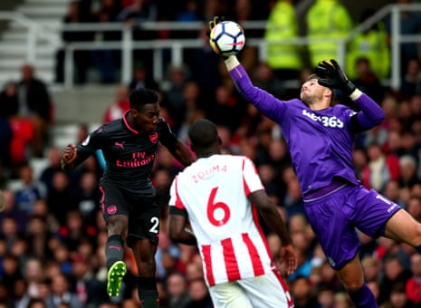 Jack Butland of Stoke City beats Danny Welbeck of Arsenal to the ball.