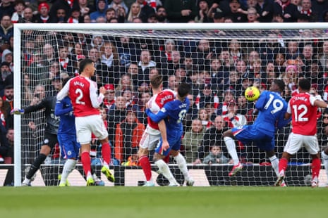 William Saliba of Arsenal scores the opening goal via a deflection from Mamadou Sarr of Chelsea.