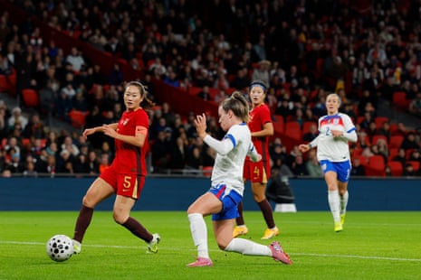 Lauren Hemp slots the ball home for England's third goal against China.