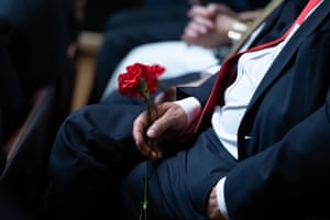 A Portuguese deputy holds a carnation during the commemorative session at the Portuguese parliament