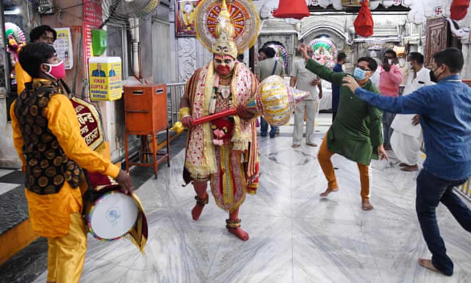 Worshippers dance and pray as a Hindu temple formally reopens in New Delhi on Monday