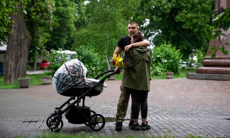 A couple comfort each other during the funeral of Ukrainian soldier Vyacheslav Radionov, killed during fighting in Bakhmut, Donetsk region, during funeral service in Poltava on 23 May 2023. 