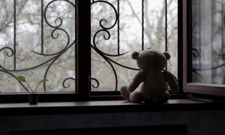 A teddy bear in a window