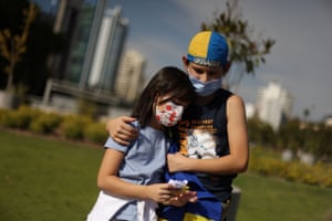 Children hug during an anti-war protest in front of the Russian embassy in Santiago, Chile