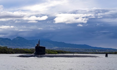 The top of the Virginia-class fast-attack submarine USS Missouri is seen just above the water as it departs Joint Base Pearl Harbor-Hickam