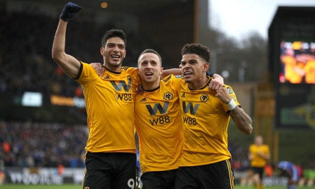 Diogo Jota celebrates scoring Wolves’ first goal against Cardiff with teammates.