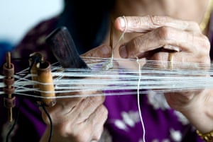 A Parsi woman ties a kusti, the sacred thread worn by Zoroastrians.