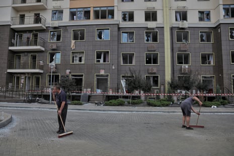 Local residents remove debris at a site of an apartment building damaged during Russian missile and drone strikes near Odesa.