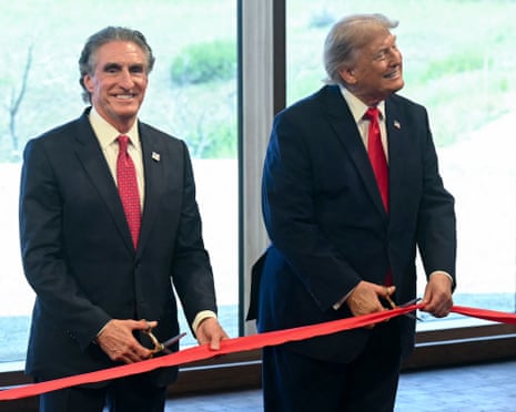 Doug Burgum and Donald Trump take part in a ribbon cutting during a ceremony at the newly opened Theodore Roosevelt Presidential Library.