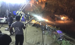 Relatives hold fishing nets, as a symbol to fish out lost spirits inside the cave.