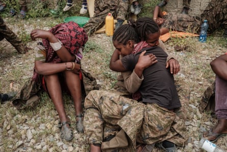 Captive Ethiopian female soldiers console each other upan their arrival to the Mekele Rehabilitation Center in Mekele, the capital of Tigray region, Ethiopia, on July 2