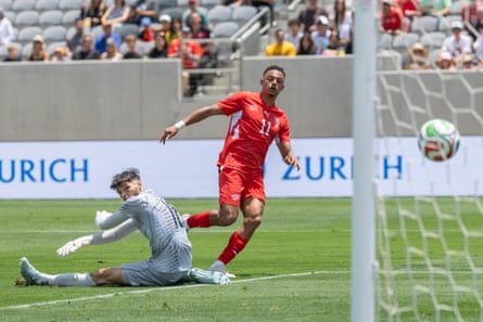 Dan Ndoye slots the ball past Patrick Beach to open the scoring.