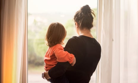 Mother and young child looking out of window
