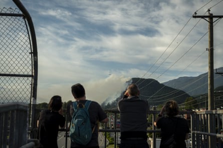 People watch a wildfire burn