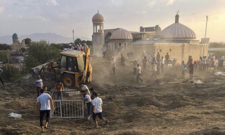 Uzbek workers clean an area of the central cemetery in Samarkand in photographs posted by the central Asian news website Fergana.ru.