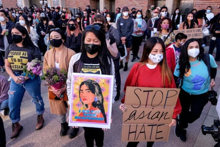 people at rally hold signs such as ‘stop Asian hate’ and ‘I am not your scapegoat’