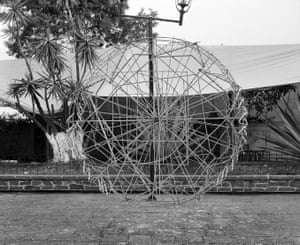 A sphere of metal rods, twice the height of a person, in the streets of Mexico City