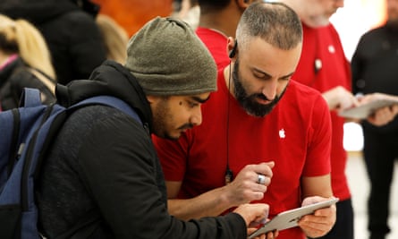 At the World Trade Center Apple store, an in-house “genius” helps a customer.