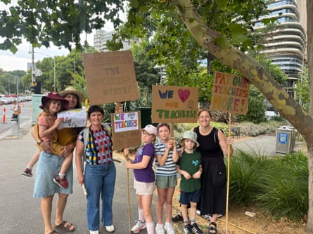 Parent Helen Bell (right) and her friends brought their children to the rally to support their teachers.