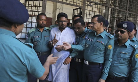 Police escort one member of an Islamist militant group in Dhaka after he was sentenced to death for an attack on a cafe in 2016