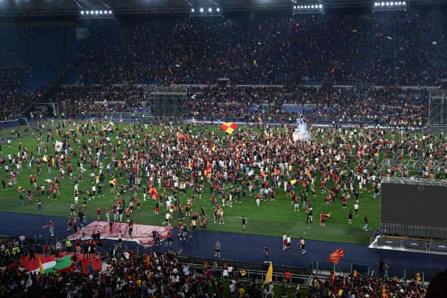 The non-travelling fans celebrate on the Stadio Olimpico pitch in Rome after their team won the Europa Conference League final in Tirana.
