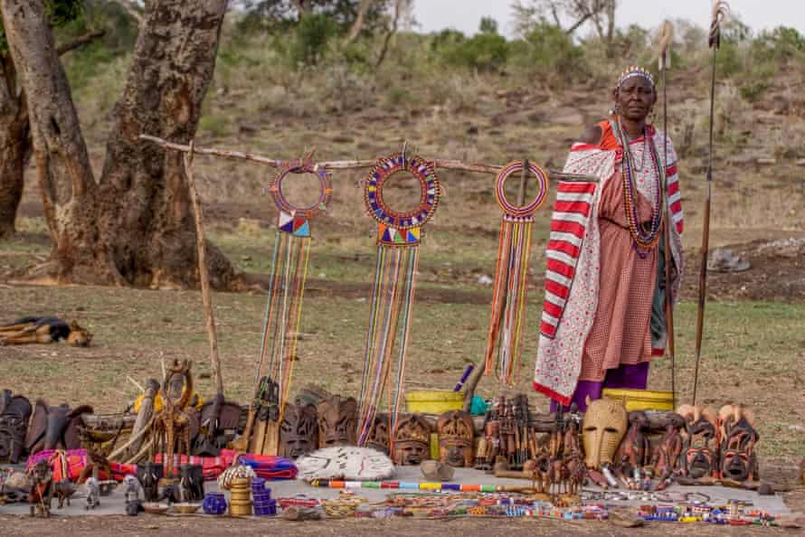 A Masai woman wearing selling decorative pearls to tourists.