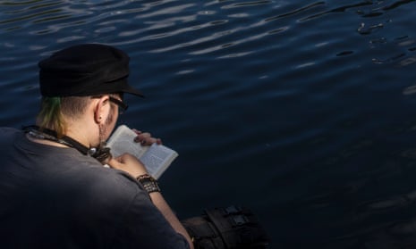 Reading along the Grand Union Canal in Camden