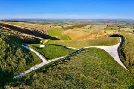 Close up of white horse in chalk on green downs on a sunny day