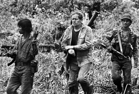 Sandinista soldiers lead captured US mercenary Eugene Hasenfus through the jungle after shooting down his Contra supply plane, October 7, 1986
