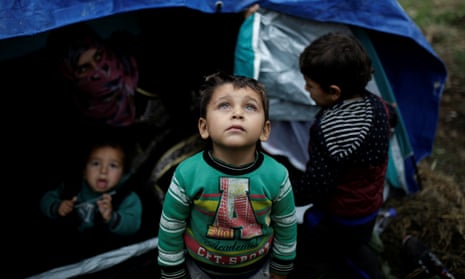 Syrian children in front of their tent next to the Moria camp.