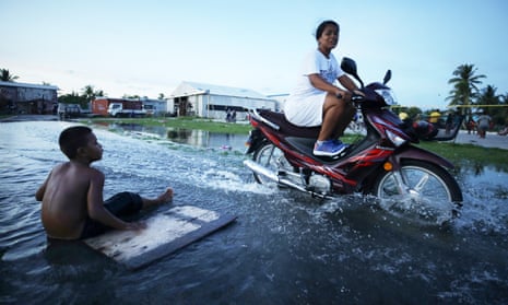 Zelenskiy Calls For Russia To Lose Un Veto Power; Un Chief Says ‘Humanity Has Opened Gates Of Hell’ On Climate 4 A woman rides her scooter through floodwaters occurring around high tide in a low lying area near the airport on November 27, 2019 in Funafuti, Tuvalu. Sea water sometimes percolates up through the porous coral land in the area during high tides. The low-lying South Pacific island nation of about 11,000 people has been classified as extremely vulnerable to climate change by the United Nations Development Programme.