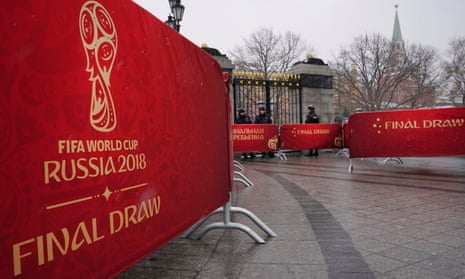 Russian policemen at the Kremlin in Moscow stand next to banners with the logo of the Fifa World Cup 2018 final draw. 