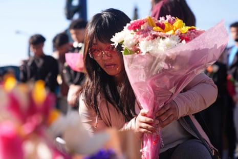 A woman places flowers at a memorial after a vehicle drove into a crowd during a Filipino heritage festival in Vancouver, British Columbia, Sunday, 27 April, 2025.