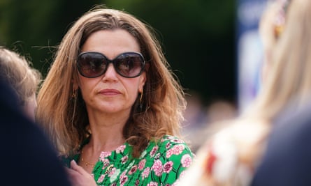 A woman with brown hair in a green floral dress
