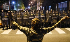 BESTPIX - Elizabeth City, North Carolina Waits For Video Release Of Police Killing Of Andrew Brown Jr.<br>*** BESTPIX *** ELIZABETH CITY, NORTH CAROLINA - APRIL 29: A protester stands with her arms raised as law enforcement officials in riot gear force people off a street as they protest the killing of Andrew Brown Jr. on April 28, 2021 in Elizabeth City, North Carolina. The police were enforcing an 8 pm curfew announced after the shooting death of Brown by Pasquotank County Sheriff deputies on April 21. (Photo by Joe Raedle/Getty Images)