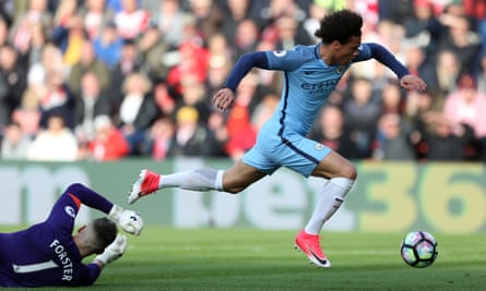 Manchester City’s Leroy Sané goes down under a challenge from Fraser Forster.