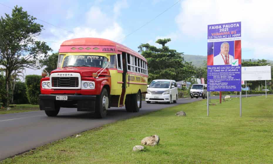 Traffic passes an election billboard