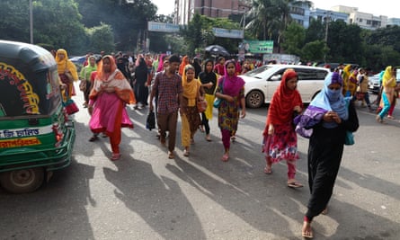 Garment workers on their way to work in Dhaka, Bangladesh. Of workers surveyed by Oxfarm in Bangladesh, 100% said they could not make ends meet.