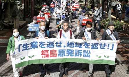 Plaintiffs and their supporters march in Japan ahead of the court ruling in Sendai on the tsunami-crippled Fukushima Daiichi nuclear power plant disaster on Wednesday