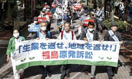 Plaintiffs and their supporters march in Japan ahead of the court ruling in Sendai on the tsunami-crippled Fukushima Daiichi nuclear power plant disaster on Wednesday.