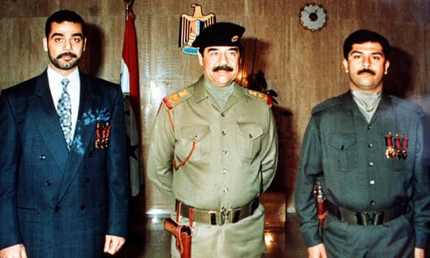 Saddam Hussein with his sons Uday (left) and Qusay.