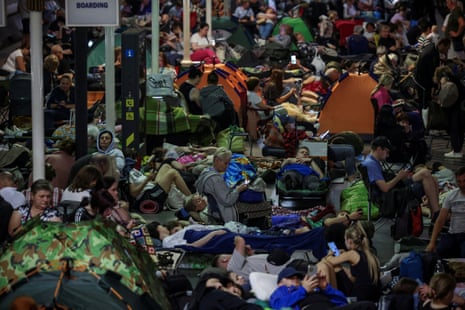 Dozens of people with tents and blankets in an underground station in Kyiv.