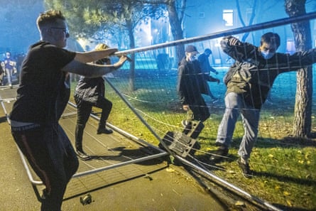 On the first day of the second lockdown, 5 November 2020, Manchester students tear down fences erected by the university around their accommodation block.
