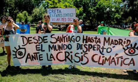 Environmental protesters in Santiago, Chile. Their banner reads: ‘From Santiago to Madrid, the world has woken up to the climate crisis.’