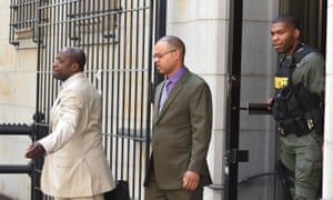 Caesar Goodson, center, leaves the courthouse.