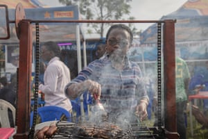 Law student Stéphanie Mbafumoja fries fish on an outdoor food stall